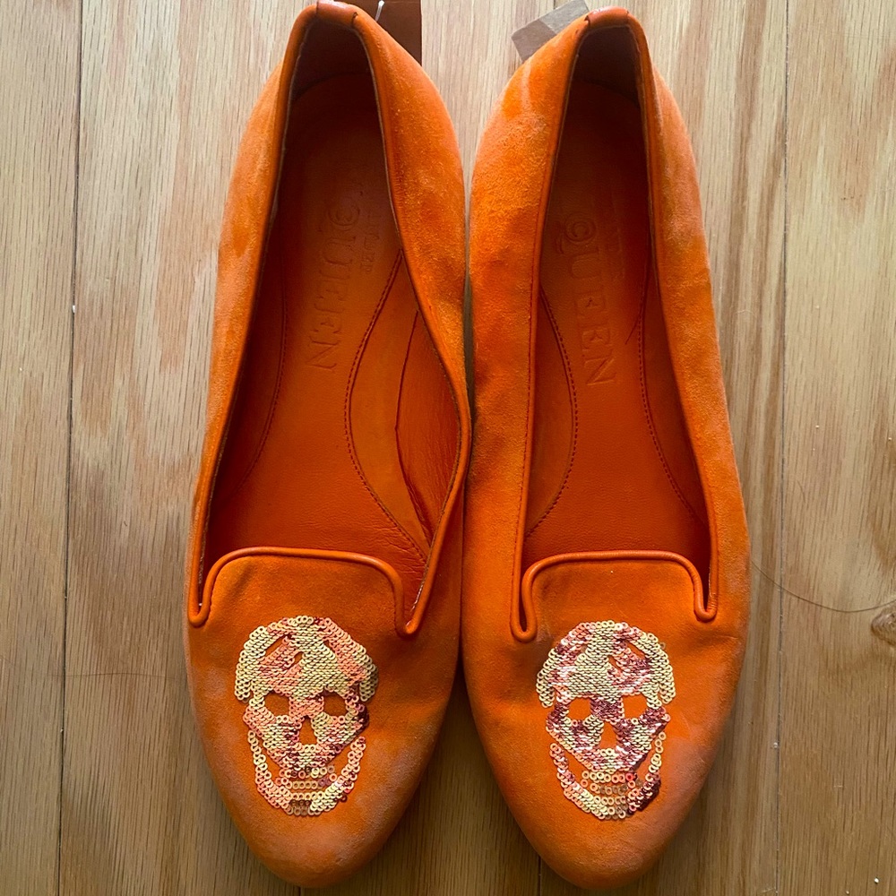 Alexander McQueen orange flats with sequin skulls